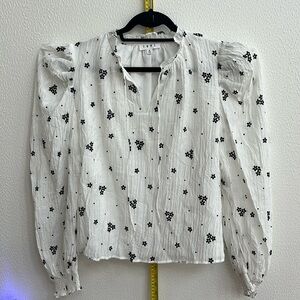 Pretty white blouse with black flowers & puffy long sleeves. The blouse is lined